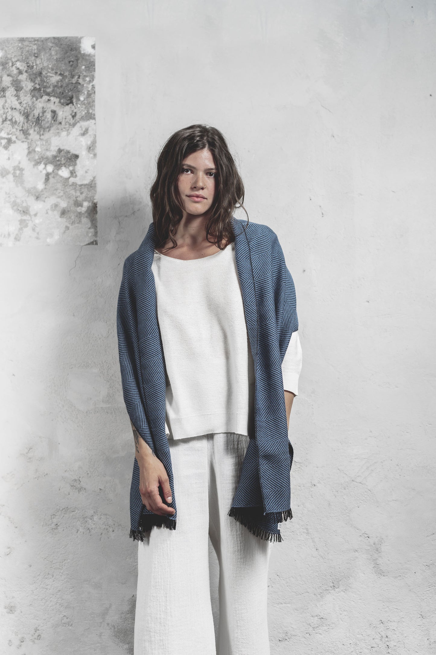 Modella con scialle azzurro tessuto a mano in pura lana merino